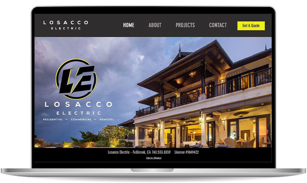 losacco-electric A laptop display shows the homepage of Losacco Electric's website, featuring a large luxurious house, navigation menu, and company logo.